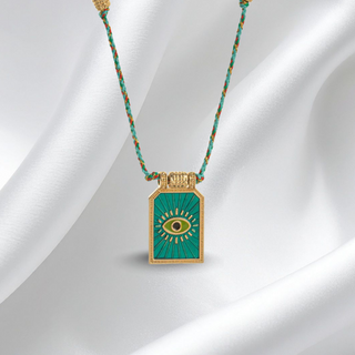 Necklace with a green pendant on a white fabric background