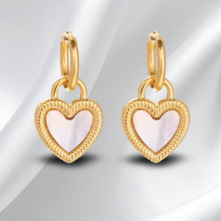 Gold heart-shaped earrings with a soft pink center on a white background