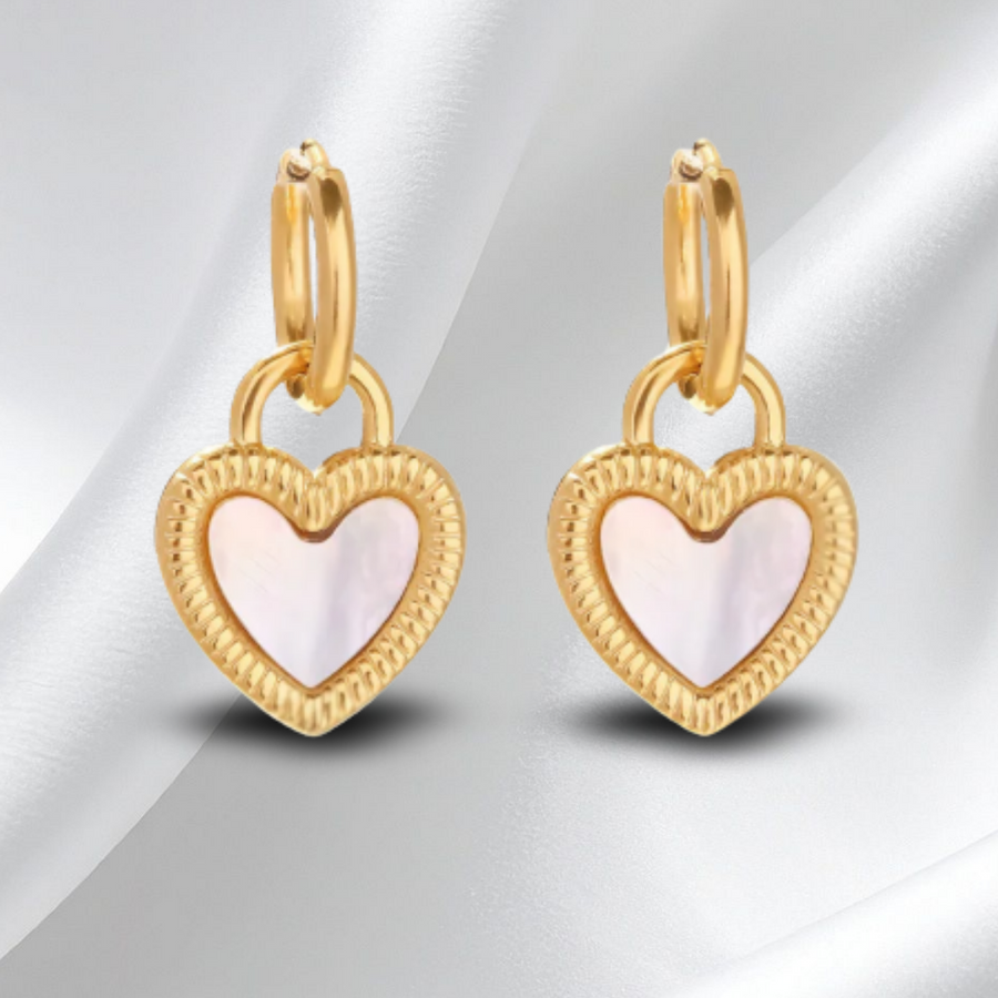 Gold heart-shaped earrings with a soft pink center on a white background