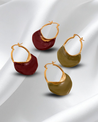 Two pairs of earrings, one red and one green, on a white background