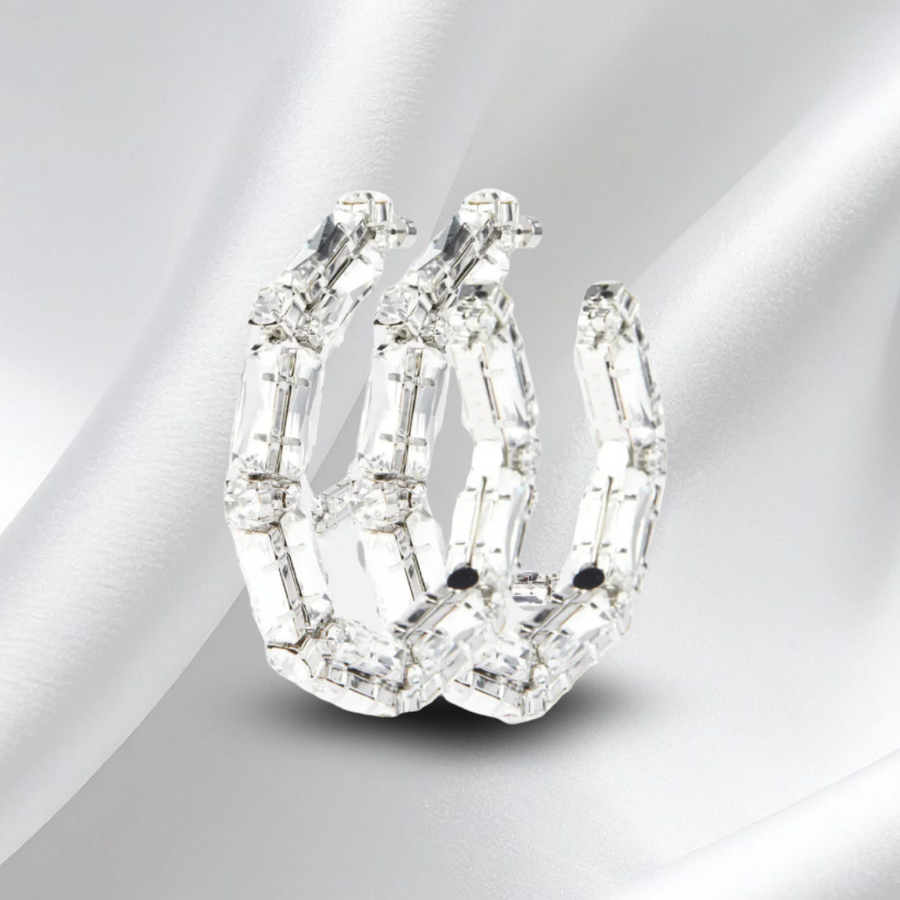 large diamond hoop earring on a white satin background