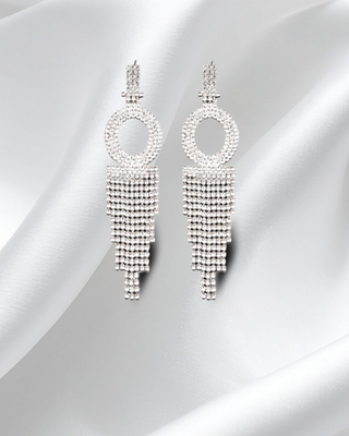 Pair of silver beaded earrings on a light gray background