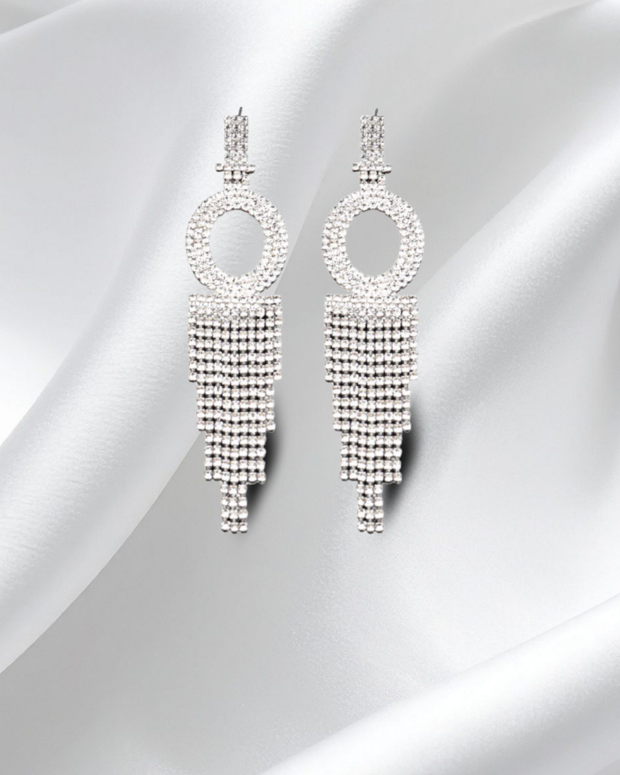 Pair of silver beaded earrings on a light gray background