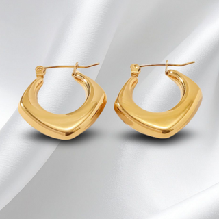Gold hoop earrings on a white background