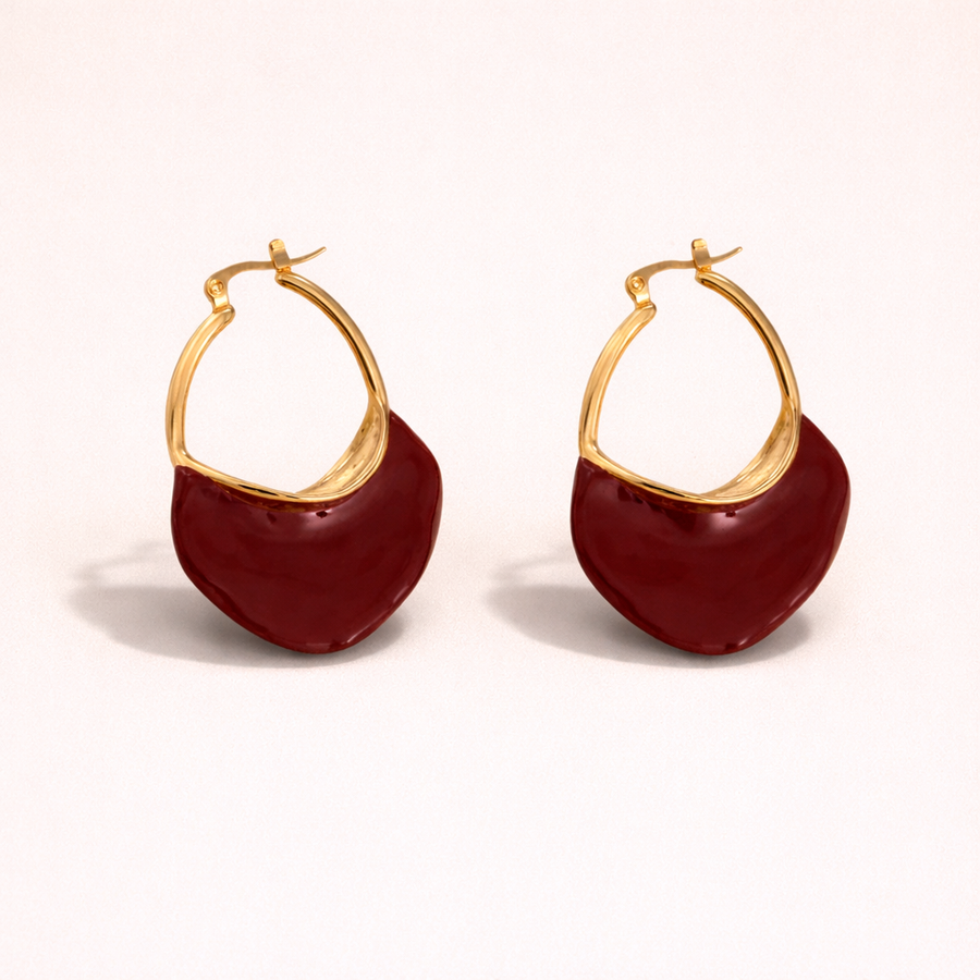Asymmetric earrings with red circular charms 