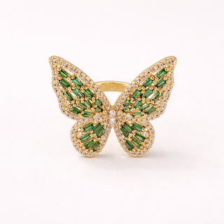 Gold butterfly ring with green gemstones