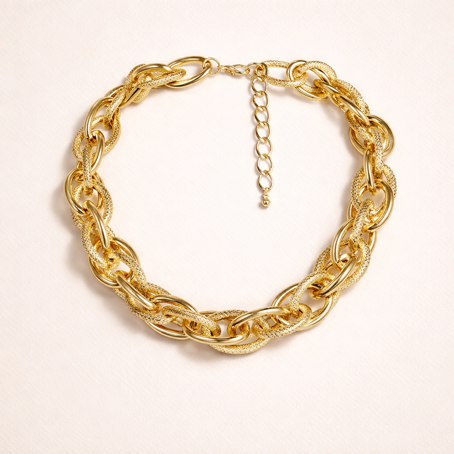 A bold woven gold necklace with a chunky silhouette, designed to elevate any look with modern statement style.