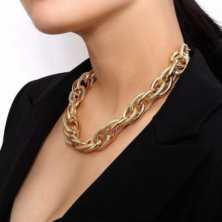 A bold woven gold necklace with a chunky silhouette, designed to elevate any look with modern statement style.