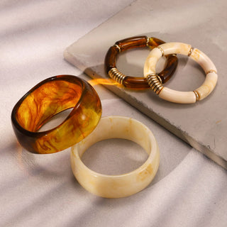 Three tortoiseshell bangles on a textured surface