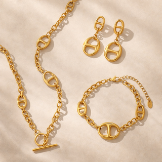 Eclipse Chain gold oval link jewelry set with statement toggle necklace, matching bracelet, and drop earrings in luxury gold finish