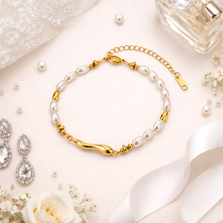 Gold Pearl Cascade bracelet on a decorative surface with flowers 
