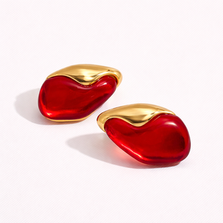 Pair of red earrings with gold tops