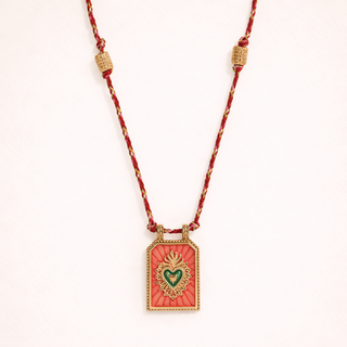 Necklace with a rectangular pendant featuring a heart design 