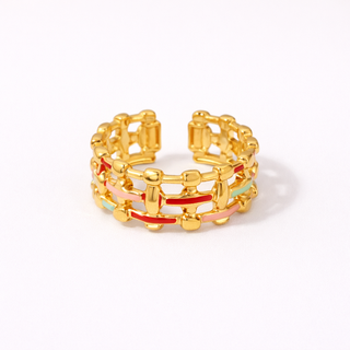 Stack of gold rings with colorful accents on a white background