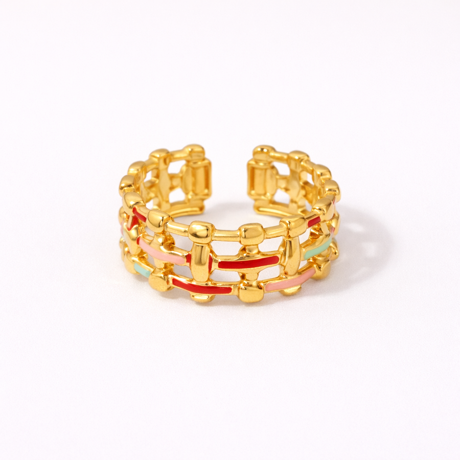 Stack of gold rings with colorful accents on a white background