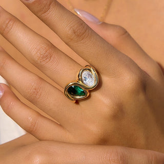 Close-up of the Bezel Emerald Ring worn on a hand, showing the bezel-set stones