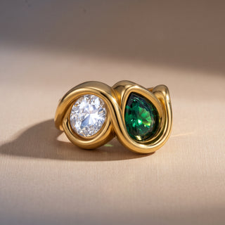 Bezel Emerald Ring product shot on a beige background, showing the bezel-set clear and emerald zircon stones