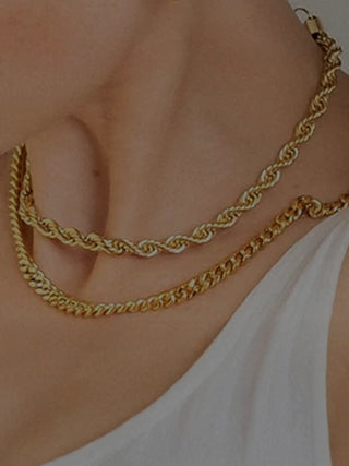 wearing layered gold chain necklaces on neck with elegant minimalist style