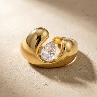 Open Dome Ring in 18K gold on a neutral background, showing the open band and pear-cut zircon