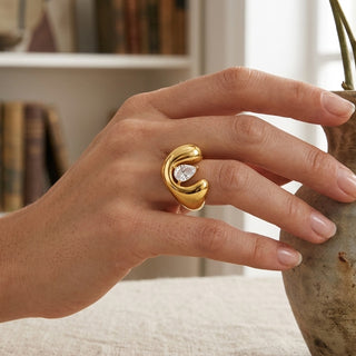 Open Dome Ring worn on a hand with a bookshelf in the background