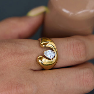 Close-up of the Open Dome Ring worn on a finger, showing the bezel-set pear-cut zircon