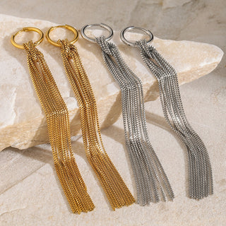 Two gold and two silver chain keychains on a stone surface