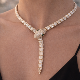 Luxury diamond necklace with a unique design on a person's neck.