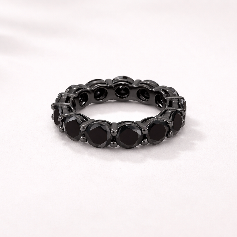 Black ring with embedded stones on a white background