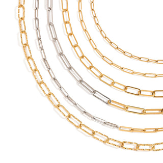 Three gold and silver chain necklaces on a white background