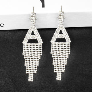 Pair of silver beaded earrings on a black background