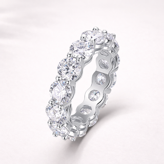 Silver ring with multiple diamonds on a white background