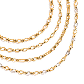 Three gold chain necklaces on a white background