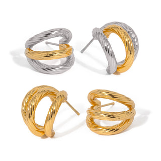 Pair of gold and silver hoop earrings on a white background